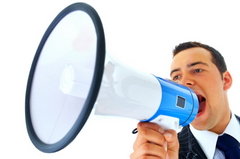 Photo of a man speaking into a megaphone to demonstrate that soundproofing is required when there are noise problems.